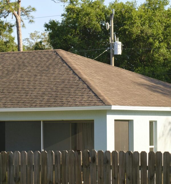 Closeup of house roof top covered with asphalt or bitumen shingles. Waterproofing of new building